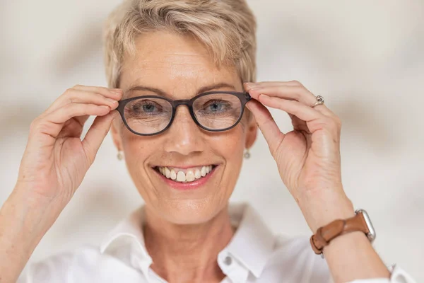 stock image Mature woman, face and vision glasses in fashion or style eye care for healthcare insurance, medical wellness or glaucoma support. Smile portrait, happy person and optometry prescription eyes lenses.