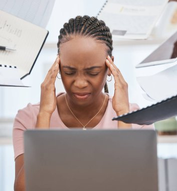 Stress headache, burnout and black woman overwhelmed with workload at busy office computer. Frustrated, overworked and tired woman with laptop at startup, anxiety from deadline time pressure crisis