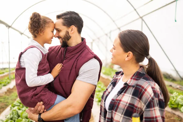Farm, family and children with a girl, man and woman working in a greenhouse together for the growth of fresh produce. Agriculture, love and kids with a mother, father and child farming for harvest.