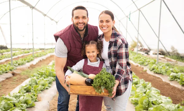Family, vegetables and greenhouse for eco friendly farming, smile or organic produce for fresh items and happy. Agriculture, farmer and parents with kid, garden for healthy food, nutrition or harvest.