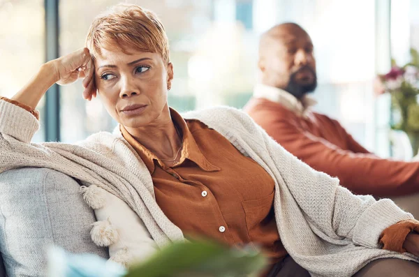 Mature couple, divorce and fighting on sofa in house, home living room or marriage counseling therapy. Stress, frustrated or depression for black woman and man in psychology counselling for cheating.