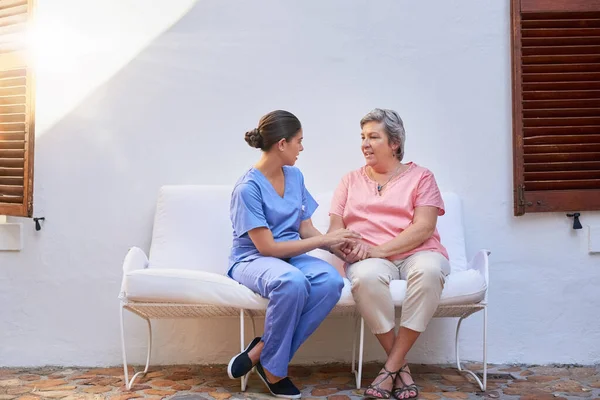 Your support matters more than you know. a caregiver chatting to a senior patient outside