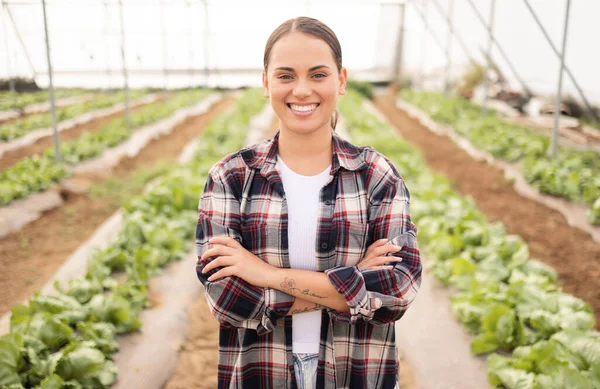 Agriculture, farming and woman farmer in a greenhouse with sustainable plants and pride for growth and development of eco environment. Portrait of female on a farm in countryside for sustainability.