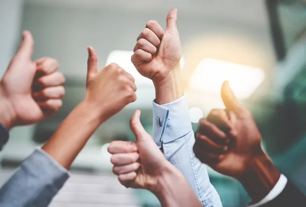 stock image Keep up the amazing work. a group of unrecognizable businesspeople showing thumbs up in an office