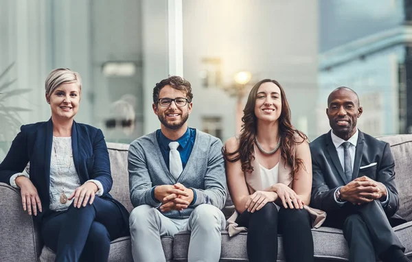 Collaborating is the surest way to get ahead. Cropped portrait of a group of businesspeople sitting on a couch in an office