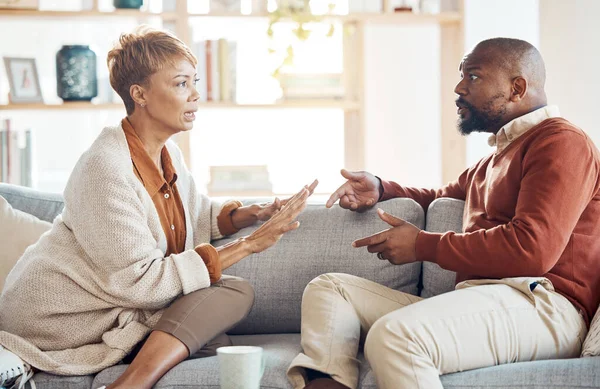Marriage problem, argument and couple on sofa angry and talking about finance, home mortgage loan or a serious decision. Communication, family law and talking of black people with divorce discussion.