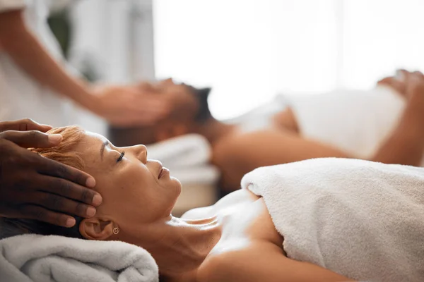 Woman, head massage or couple spa in relax wellness hotel or salon for romantic holiday, break or bonding date. Massage therapist, hands and reiki for headache, stress management or luxury healthcare.