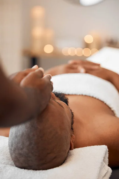 Black man, head massage or relax spa in relax hotel, wellness salon or luxury resort for self care, mental health or peace. Massage therapist, hands and zen aromatherapy for healthy stress management.