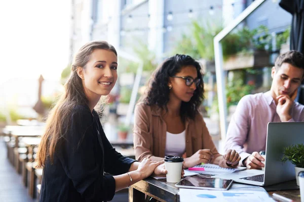 stock image Weve been discussing so many bright ideas. Portrait of a young designer having a meeting with her colleagues at a coffee shop