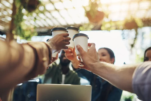 Stock image That deserves a toast. a group of creative employees toasting with coffee cups outside