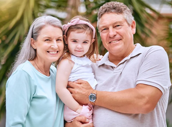 stock image Garden, family and grandparents portrait with young child smile for bond, care and happiness together. Happy, senior and grandmother with grandpa holding girl in Australia for retirement leisure