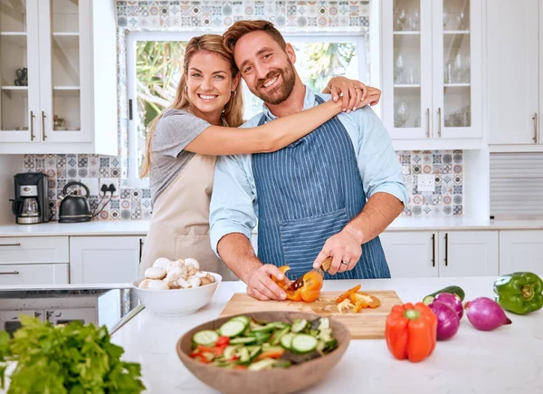 Food, health and cooking couple with vegetables for a healthy organic vegan diet with nutrition and vitamins. Kitchen, love and happy woman enjoys hugging, dinner or lunch preparation with partner.