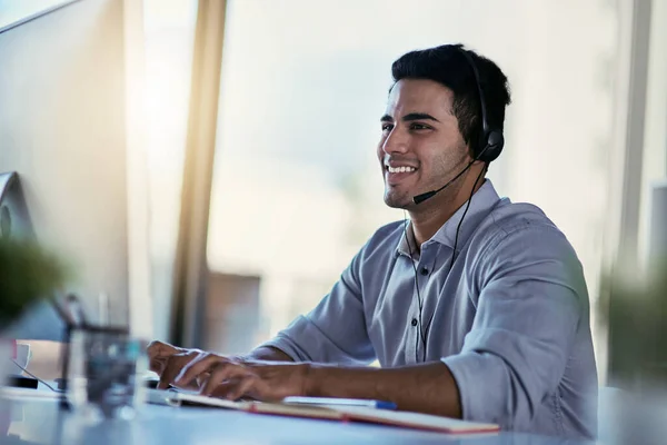 stock image He always goes the extra mile for his clients. a call centre agent working in an office