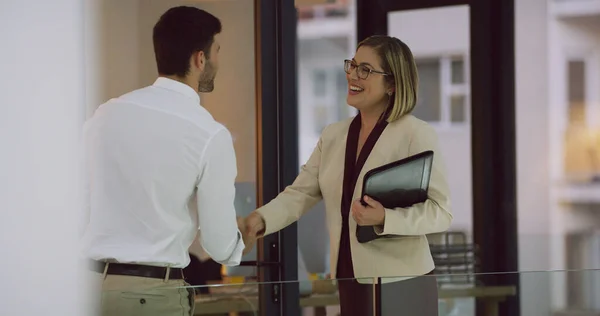 stock image Its a pleasure to meet you. two businesspeople shaking hands while standing in the office lobby