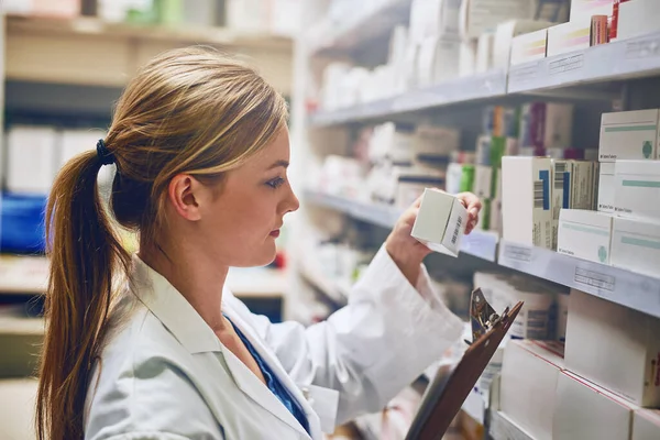 I know every product on my shelf. a pharmacist looking at medication on a shelf