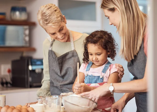 Grandma, mother and child baking in kitchen together while girl learns to mix cake mixture, pancake batter or muffin mix. Family cooking dessert, kid learning and cooking snack food for home dinner.