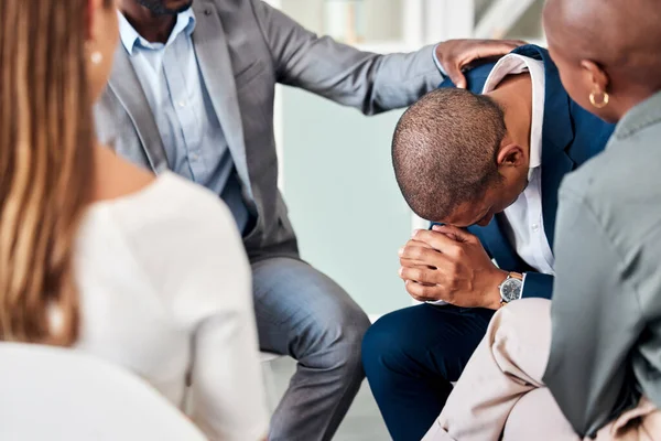 Group therapy, support and counseling with a business man and team in a meeting for emotions or healing. Mental health, psychology and rehabilitation with a male employee in a session for growth.