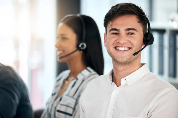 Man, consultant and call center with smile for customer service, telemarketing or advice at the office. Happy male employee smiling with headset in contact us, consulting or desktop support agency.