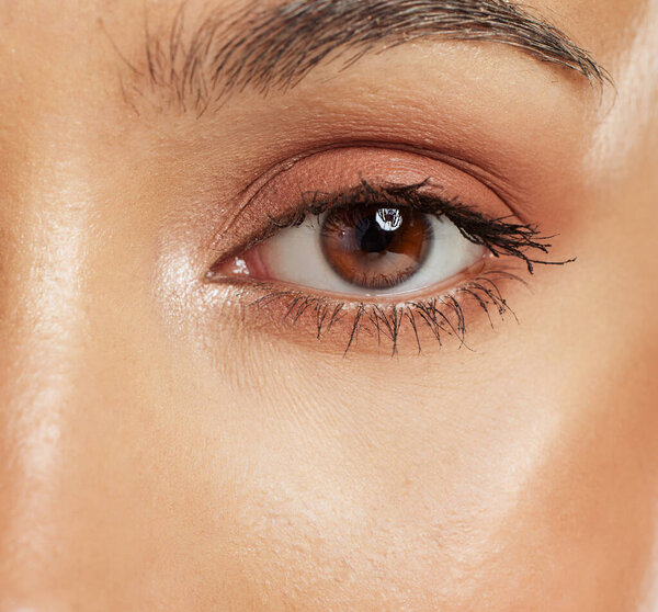 Beauty, mascara and closeup of an eye with cosmetics, natural makeup and neutral eyeshadow. Vision, lashes and macro zoom of a woman with a brown iris with face or skin cosmetic products