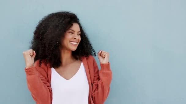 成功は興奮し 黒人女性が勝利し 青のモックアップスタジオの背景に対する達成を祝う 発表のための販売とダンスを祝う笑顔でアフリカの勝者の肖像 — ストック動画