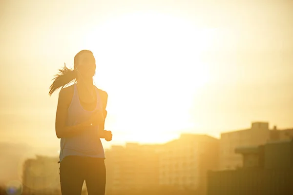 stock image Increase your fitness by running more often. a sporty young woman out for a run in the city