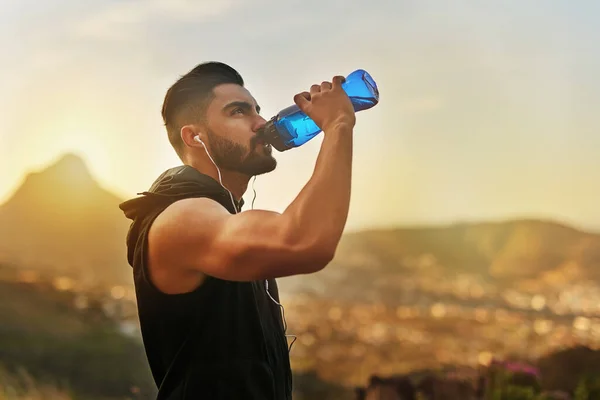 stock image That work out made me thirsty. a young man exercising outdoors