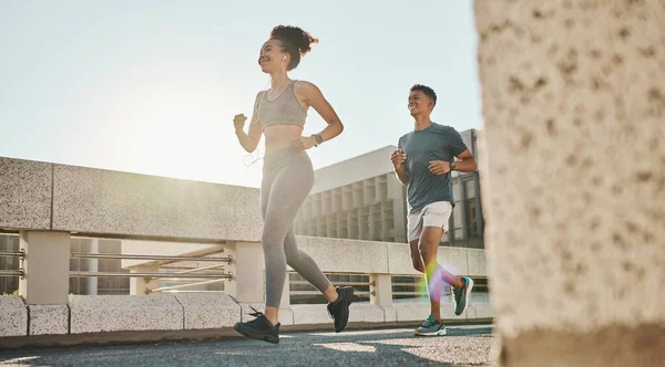 stock image Fitness, couple and running workout in city, urban town and sunshine for exercise, healthy lifestyle and wellness. Young man, woman and runner partner with motivation of cardio, marathon and training.