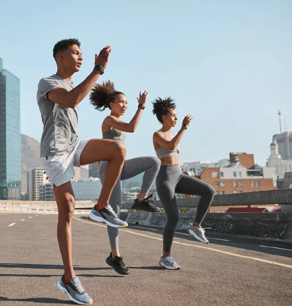 Diversity, fitness friends or runner stretching in city for marathon, running exercise or sports workout. Wellness, teamwork health or group of athlete training for warm up , sport or street race.