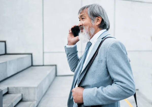 stock image Asian man, business leader and phone call for marketing planning, conversation and communication to connect. Leadership, male entrepreneur and smartphone for discussion, talking or marketing strategy.