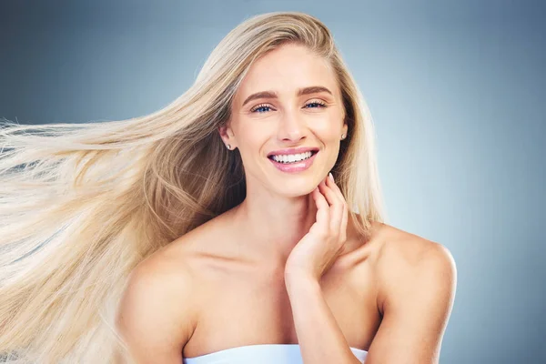 Beauty, hair care and portrait of happy woman in studio with long, healthy and blond hair. Health, cosmetics and model from Australia with beautiful hairstyle after keratin, botox or salon treatment