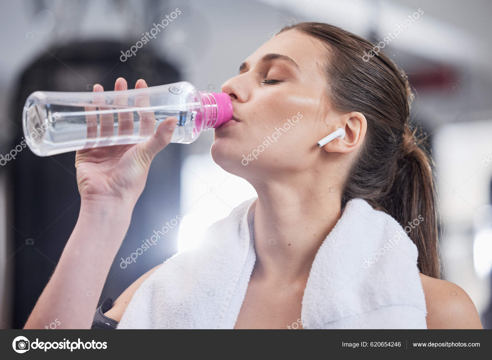 Gym Fitness Woman Earphones Drinking Water Bottle Cardio Workout While  Stock Photo by ©PeopleImages.com 620654246