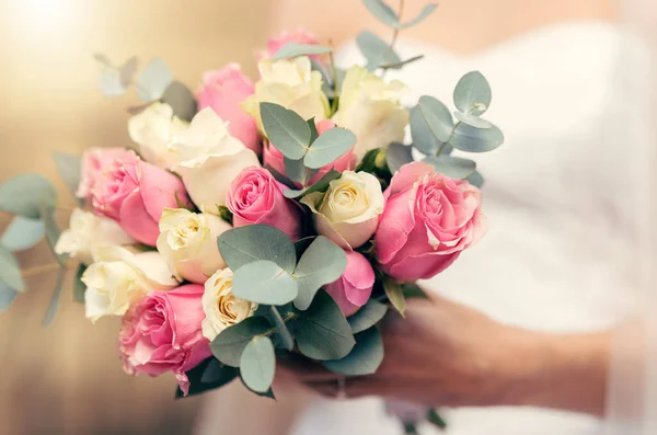 Wedding, flowers and rose bouquet of bride ready to walk isle for marriage, catholic religion ceremony and life commitment. Boutique floral arrangement, yellow and pink roses in womans hand to marry.