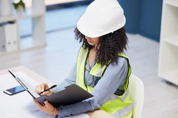 Document, writing and construction worker or engineer black woman paperwork, insurance checklist and logistics management in office. Builder, contractor or architect project planning site development.