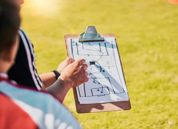 Clipboard, game planning and on field for soccer, sports and outdoor for competition with coach. Football, strategy and communication for instructions, talking and paper for match day formation