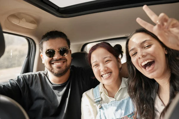 Travel, road trip and car with people or friends portrait excited for journey, holiday or vacation together. Gen z group of people with peace sign driving for safety, transportation and adventure.