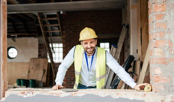 Architect, building and smile on construction site for project architecture, industrial plan or maintenance safety. Portrait of happy professional engineer or builder working and smiling for contract.