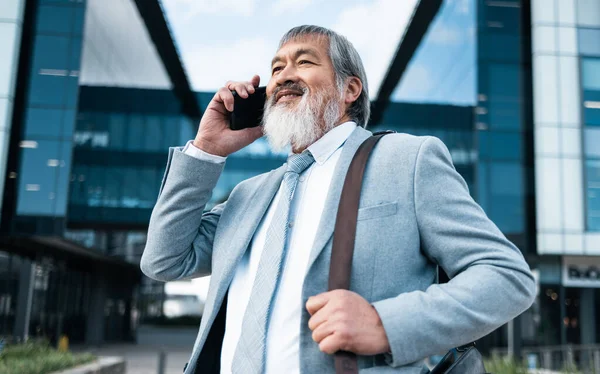 Phone call, travel or Japan businessman in city with smile for communication, networking or 5g network outdoor. Smile, happy or traveling man with phone, smartphone or tech for contact us in street.