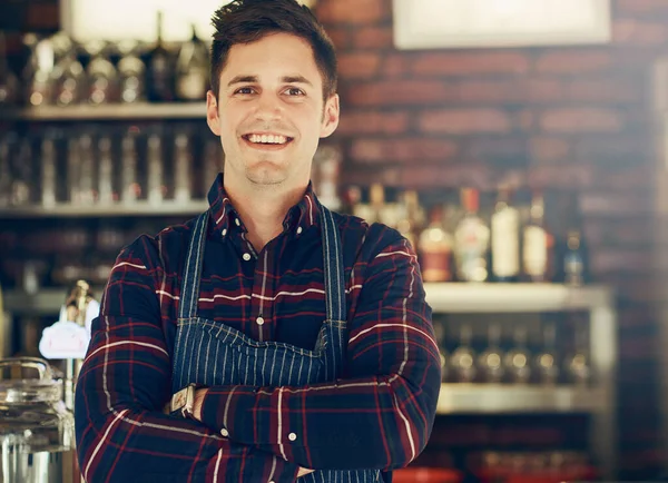 Hes the proud owner of a new restaurant. Portrait of a smiling young entrepreneur standing in a small restaurant