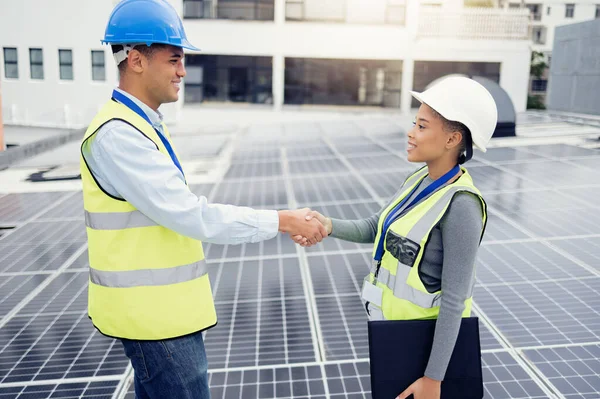 Solar energy, solar panel worker and renewable energy handshake electricity deal of sustainability, power plant development and innovation. Clean energy, sustainable technology and green construction.