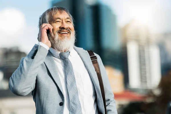 stock image Businessman, smile and phone call in the city for communication, conversation or talking in the outdoors. Happy man having a successful business discussion call on a mobile smartphone in a urban town.