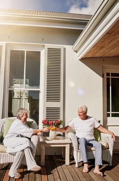 stock image Heres to the start of a relaxing chapter. a happy senior couple toasting with juice on the patio at home