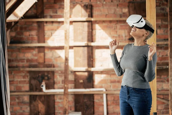 Virtual reality, metaverse and construction with a woman designer planning a home improvement with technology. Future, ai and 3d with a female architect using a vr headset on a building site.
