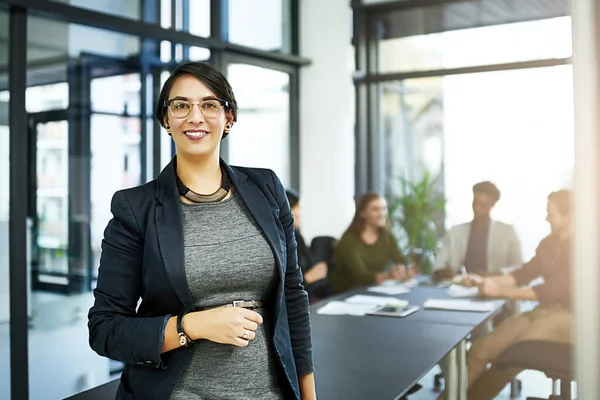 stock image Leaders are only as successful as their teams. Portrait of a businesswoman in a boardroom with her colleagues blurred out in the background