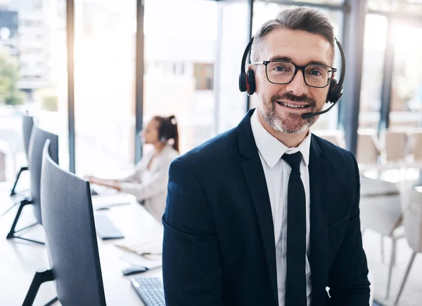 Communication, leadership and portrait of businessman at call center with vision at telemarketing company. Contact us, customer service and crm, happy ceo manager at customer service help desk office.
