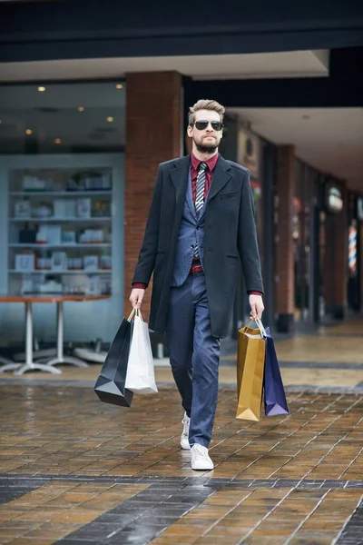 Out and about on a serious shopping spree. a well dressed young man on a shopping spree