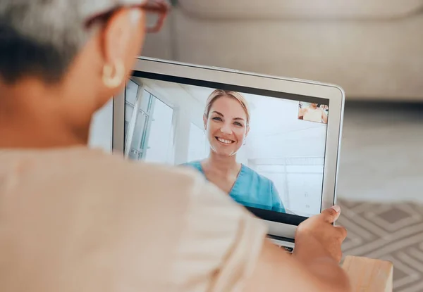 stock image Telehealth, covid and tablet with doctor and patient for consulting, checkup or conversation for health, advice or talk. Healthcare, medical professional or senior woman video call, help or in lounge.