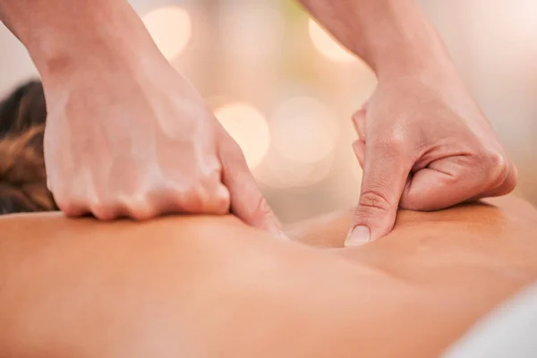 Massage therapist, hands or back massage on woman in spa muscle relief, pain management or tension release. Zoom, masseur or relax physical therapy in peace or luxury hotel salon for self care health.