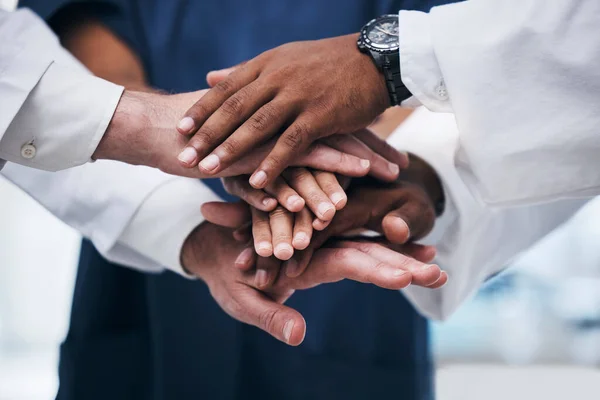 Hands, teamwork and unity with a business team of diversity standing in office with a hand each in a huddle, stack or pile. Trust, partnership and solidarity with an employee group working together.