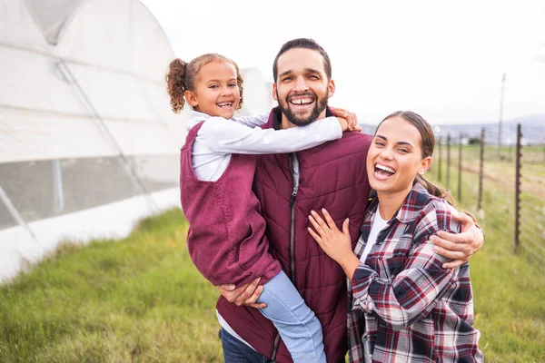 Stock image Happy family, farming and agriculture, greenhouse and field for sustainability, growth and environment in Spain countryside. Portrait of farmer parents, kid and sustainable gardening in agro industry.