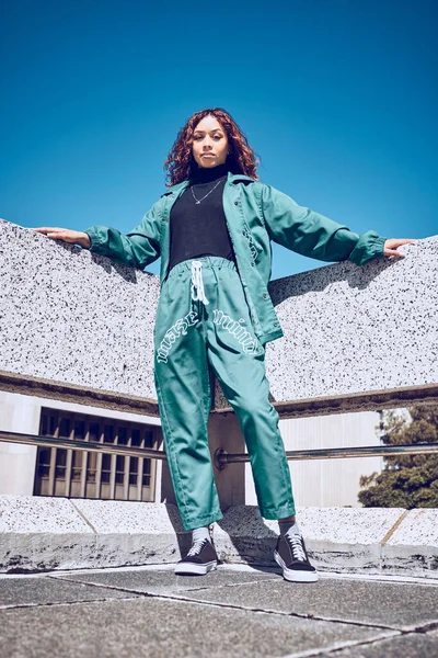 Green, designer and fashion black woman in urban city portrait pm blue sky mock up for marketing, advertising or youth promotion. Young gen z girl streetwear design clothes with mockup rooftop space.